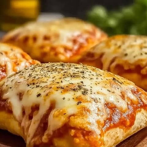 A pizza with cheese and herbs on top.