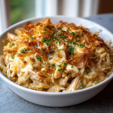 A bowl of food with a green herb on top.