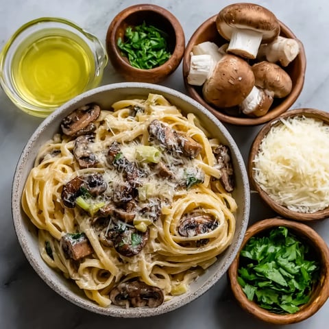 A bowl of pasta with mushrooms and cheese.