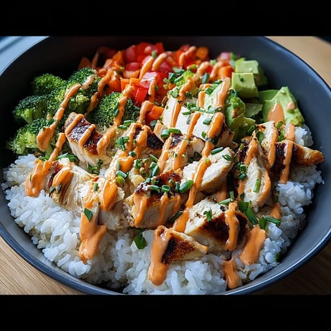 A bowl of food with rice, broccoli, and tomatoes.